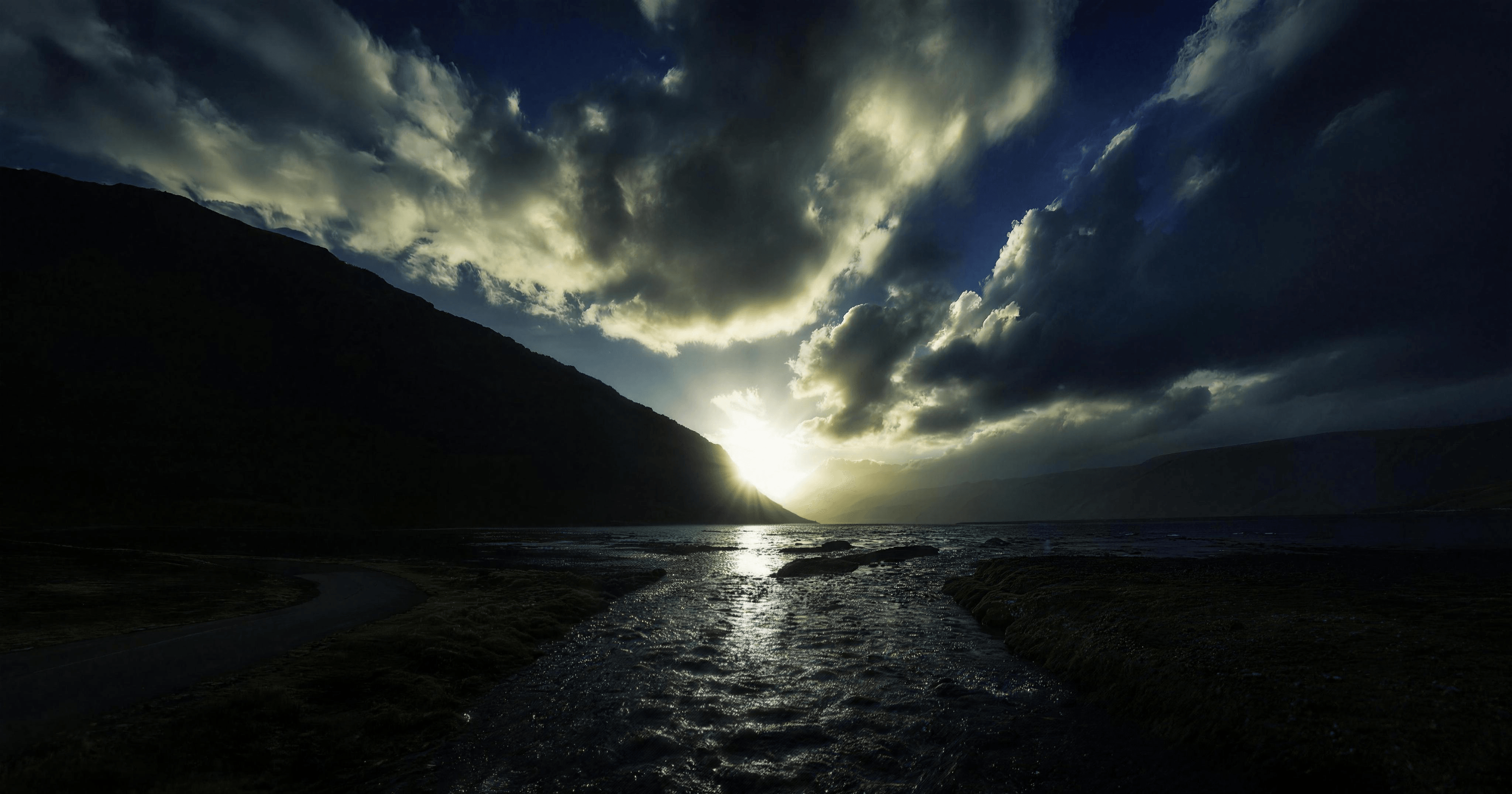 Low sun breaking through cloud over an Icelandic valley